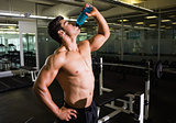 Muscular man drinking energy drink