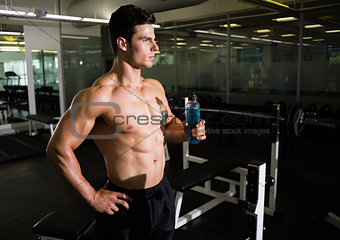 Muscular man holding energy drink
