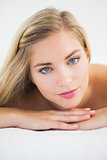 Beautiful blonde lying on massage table looking at camera