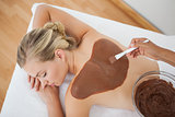 Beautiful blonde enjoying a chocolate beauty treatment