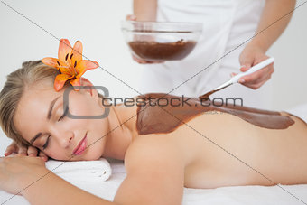 Beautiful blonde enjoying a chocolate beauty treatment