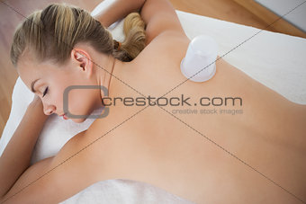 Pretty blonde with vacuum cup on her back