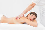 Attractive woman receiving back massage at spa center