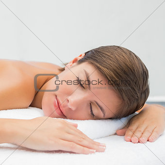 Beautiful young woman on massage table  at spa center