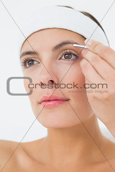 Hand applying eyeshadow to beautiful woman