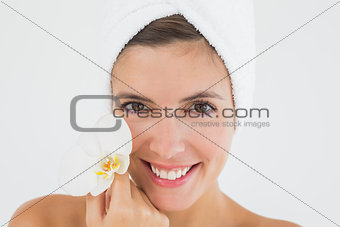 Close up of a beautiful young woman holding flower