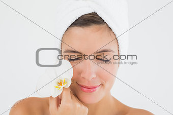 Close up of a beautiful young woman holding flower