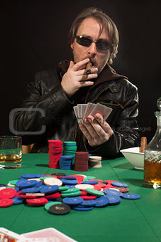 Smoking poker player wearing sunglasses