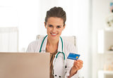 Happy doctor woman making online shopping