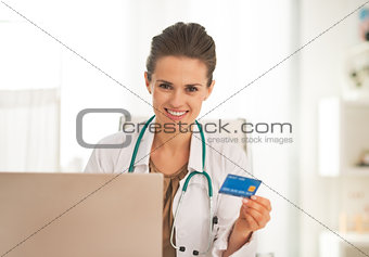 Happy doctor woman making online shopping