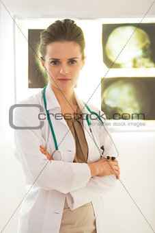 Portrait of confident doctor woman in front of lightbox