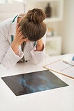 Stressed doctor woman with fluorography