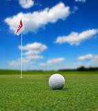 Golf ball in front of flag
