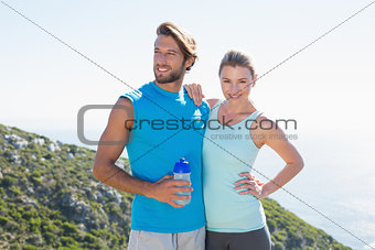 Fit couple standing at summit