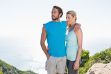 Fit couple standing at summit