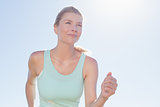 Fit woman jogging and smiling