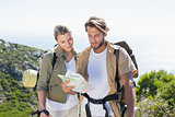 Hiking couple reading map at mountain summit