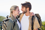 Attractvie hiking couple hugging on mountain trail