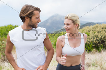 Attractive couple jogging on mountain trail