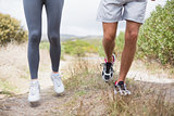 Fit couple jogging on mountain trail