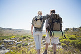 Hiking couple standing on mountain terrain