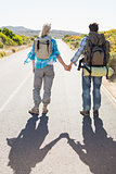 Attractive couple standing on the road holding hands