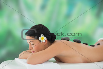 Beautiful brunette relaxing on massage table