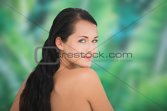 Beautiful nude brunette smiling at camera