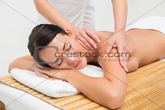 Beautiful brunette enjoying a shoulder massage