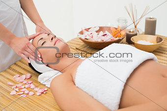 Peaceful brunette enjoying a head massage