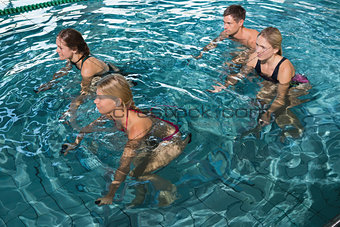 Fitness class using underwater exercise bikes