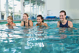Female fitness class doing aqua aerobics