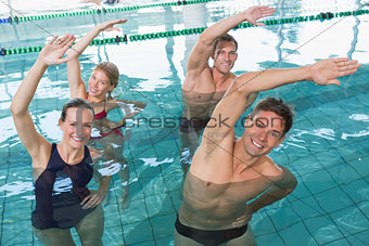 Happy fitness class doing aqua aerobics