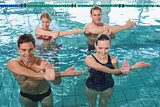 Happy fitness class doing aqua aerobics