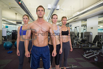Serious fitness class posing together