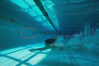 Pretty swimmer swimming underwater in bikini