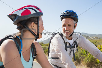 Active couple going for a bike ride in the countryside