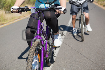 Fit couple going for a bike ride in the countryside