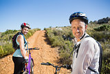 Active couple cycling on country terrain together