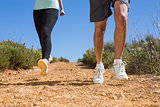 Fit couple running down mountain trail