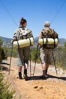 Hiking couple walking on mountain trail