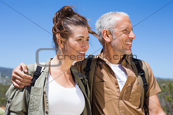 Hiking couple smiling together on mountain trail