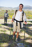 Happy hiking couple walking on mountain trail