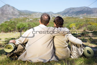 Hiking couple sitting and admiring the scenery