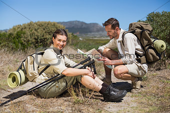 Hiking couple taking a break on country terrain