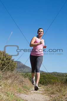 Active woman jogging in the countryside