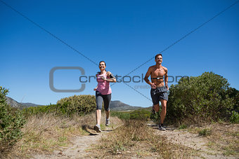 Active couple jogging in the countryside