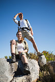 Hiking couple looking out over mountain terrain