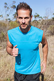 Athletic man jogging in the countryside