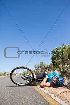 Cyclist lying on the road after an accident